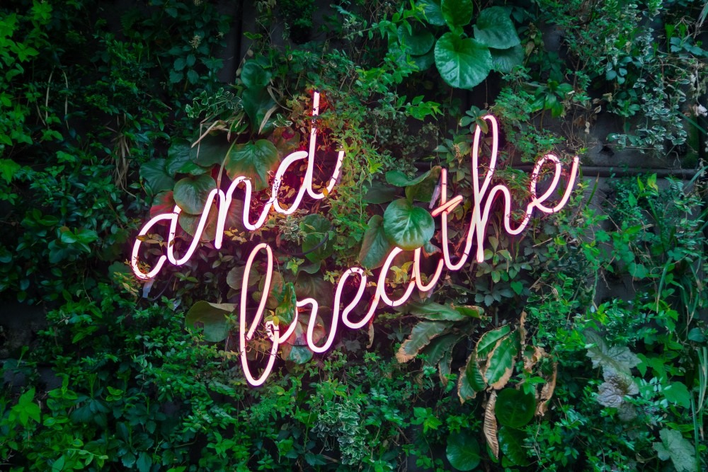 text "and breathe" in neon lights