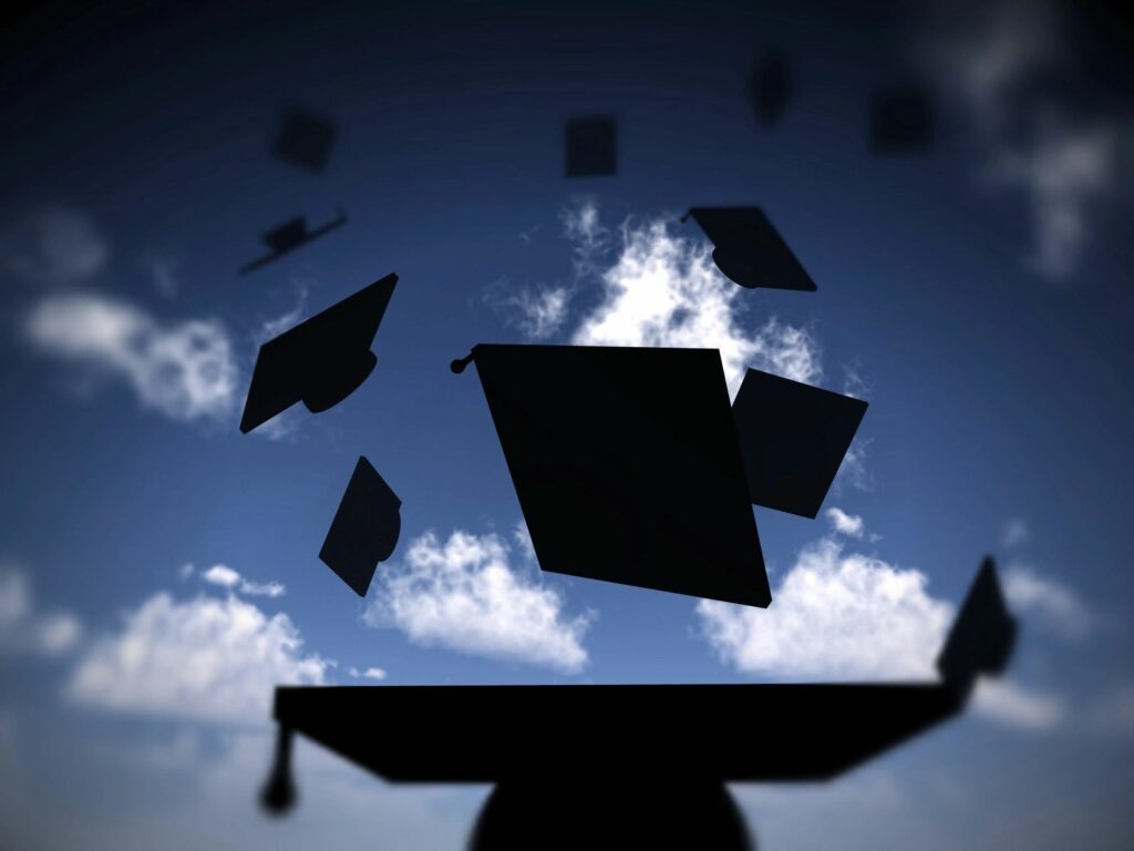 Image of University Graduation hats flying into the air